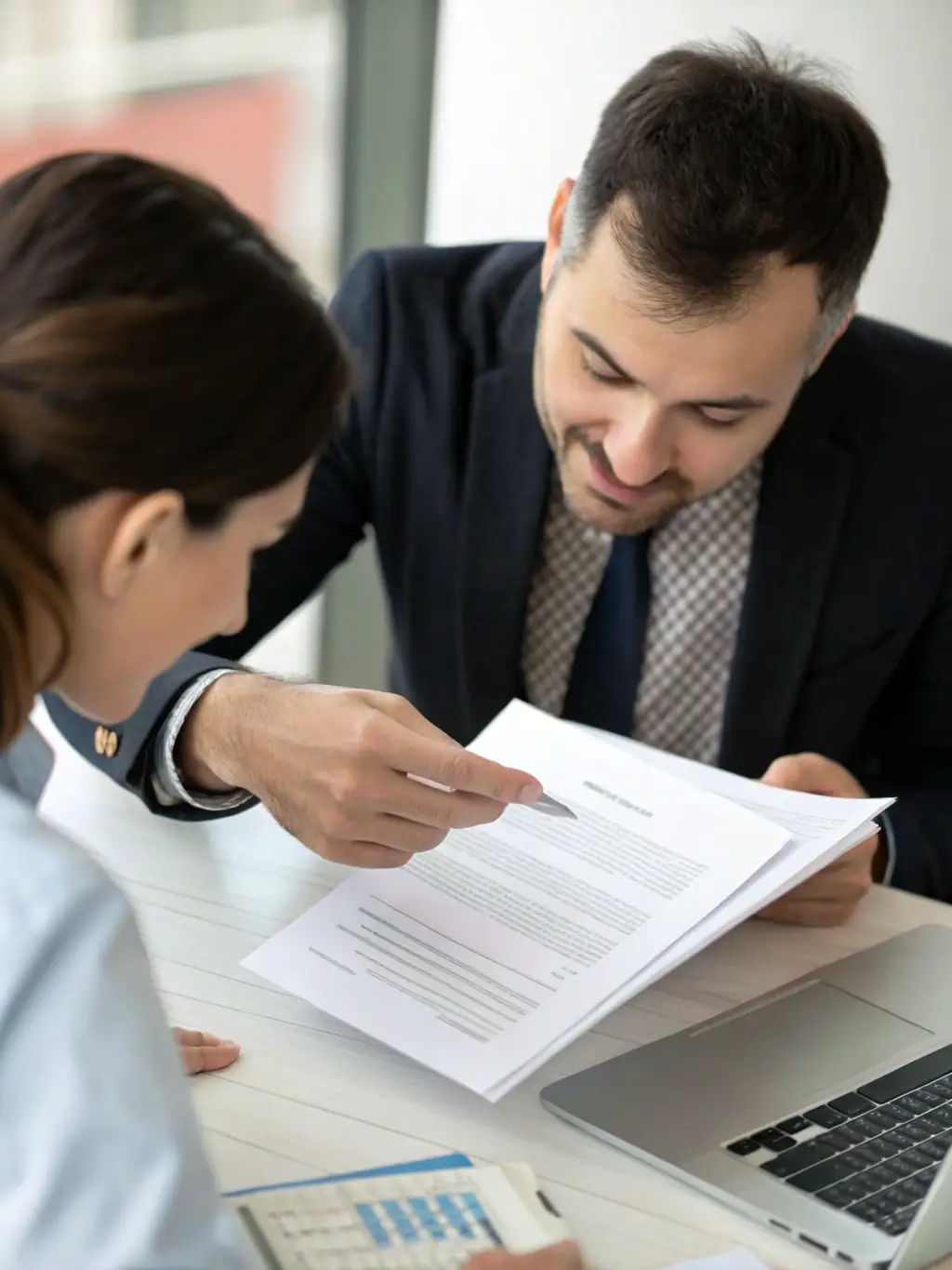 A consultant discussing visa options with a client in a modern office.